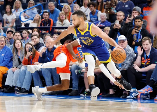 Nov 10, 2024; Oklahoma City, Oklahoma, USA; Golden State Warriors guard Stephen Curry (30) moves the ball around Oklahoma City Thunder guard Isaiah Joe (11) as he falls behind him during the second half at Paycom Center. Mandatory Credit: Alonzo Adams-Imagn Images