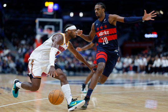 Nov 4, 2024; Washington, District of Columbia, USA; Golden State Warriors guard Buddy Hield (7) drives to the basket as Washington Wizards forward Alexandre Sarr (20) defends in the second half at Capital One Arena. Mandatory Credit: Geoff Burke-Imagn Images