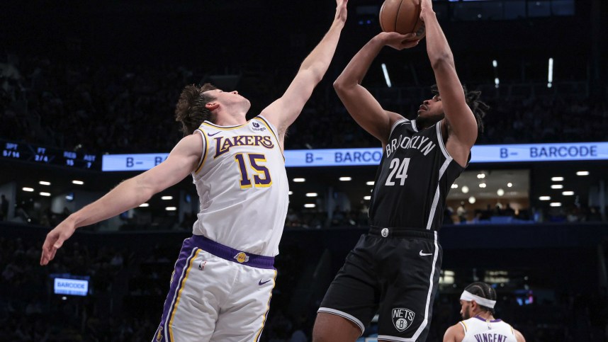 Mar 31, 2024; Brooklyn, New York, USA; Brooklyn Nets guard Cam Thomas (24) shoots the ball against Los Angeles Lakers guard Austin Reaves (15) during the first half at Barclays Center. Mandatory Credit: Vincent Carchietta-Imagn Images