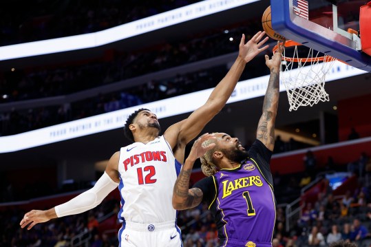 Nov 4, 2024; Detroit, Michigan, USA; Los Angeles Lakers guard D'Angelo Russell (1) shoots on Detroit Pistons forward Tobias Harris (12) in the first half at Little Caesars Arena. Mandatory Credit: Rick Osentoski-Imagn Images