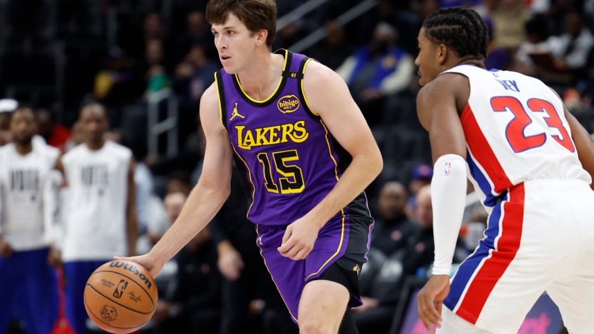 Nov 4, 2024; Detroit, Michigan, USA; Los Angeles Lakers guard Austin Reaves (15) dribbles defended by Detroit Pistons guard Jaden Ivey (23) in the first half at Little Caesars Arena. Mandatory Credit: Rick Osentoski-Imagn Images