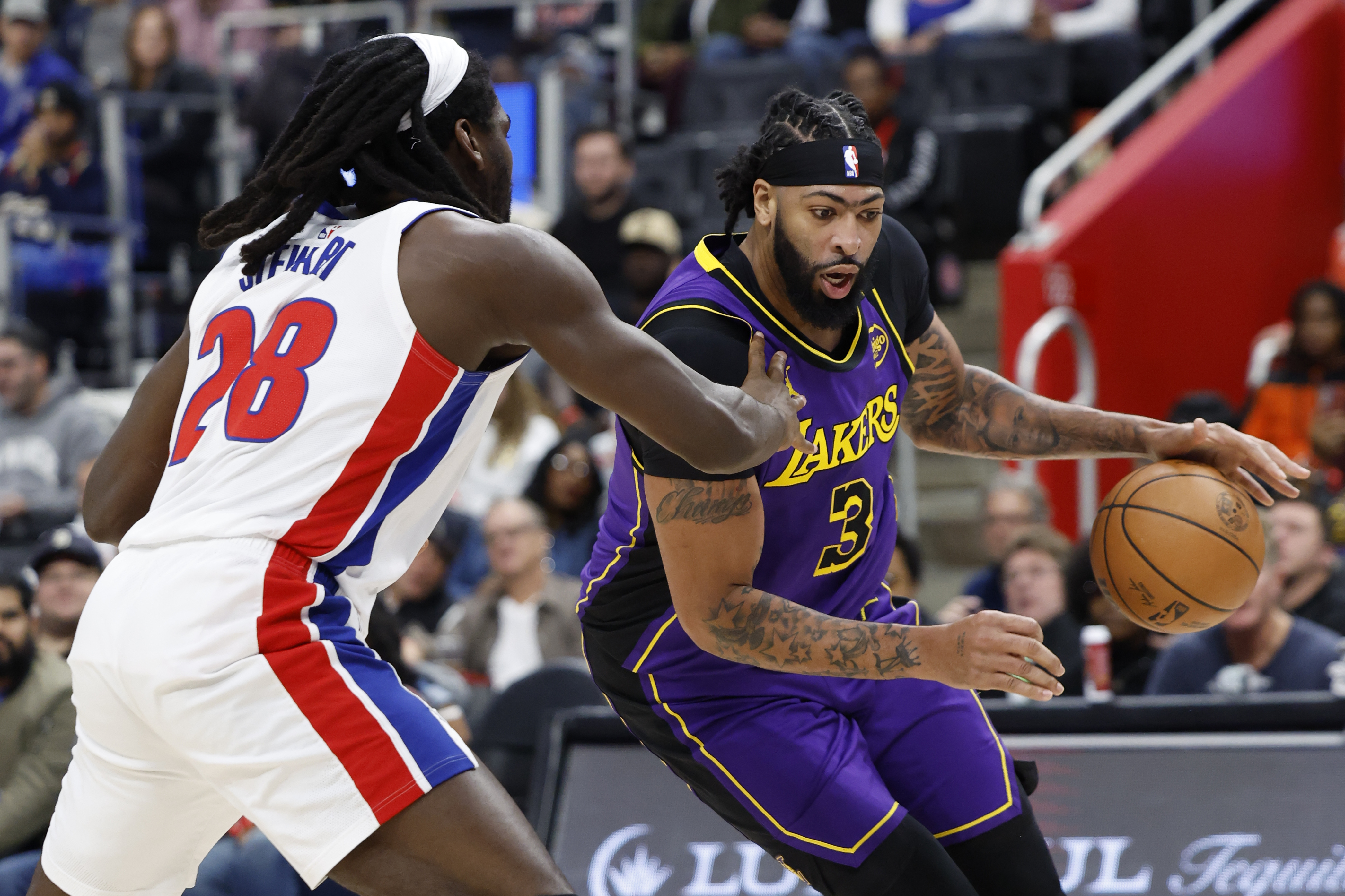 Nov 4, 2024; Detroit, Michigan, USA; Los Angeles Lakers forward Anthony Davis (3) dribbles defended by Detroit Pistons center Isaiah Stewart (28) in the first half at Little Caesars Arena. Mandatory Credit: Rick Osentoski-Imagn Images