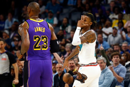 Nov 6, 2024; Memphis, Tennessee, USA; Memphis Grizzlies guard Ja Morant (12) reacts toward Los Angeles Lakers forward LeBron James (23) after a three point basket during the first half at FedExForum. Mandatory Credit: Petre Thomas-Imagn Images