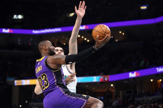 Nov 6, 2024; Memphis, Tennessee, USA; Los Angeles Lakers forward LeBron James (23 drives to the basket as Memphis Grizzlies center Zach Edey (14) defends during the first half at FedExForum. Mandatory Credit: Petre Thomas-Imagn Images