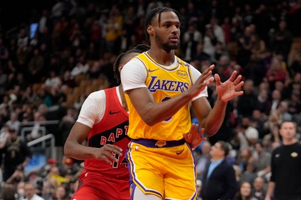 Nov 1, 2024; Toronto, Ontario, CAN; Los Angeles Lakers guard Bronny James (9) looks for a pass as Toronto Raptors guard Ja'Kobe Walter (14) defends during the second half at Scotiabank Arena. Mandatory Credit: John E. Sokolowski-Imagn Images