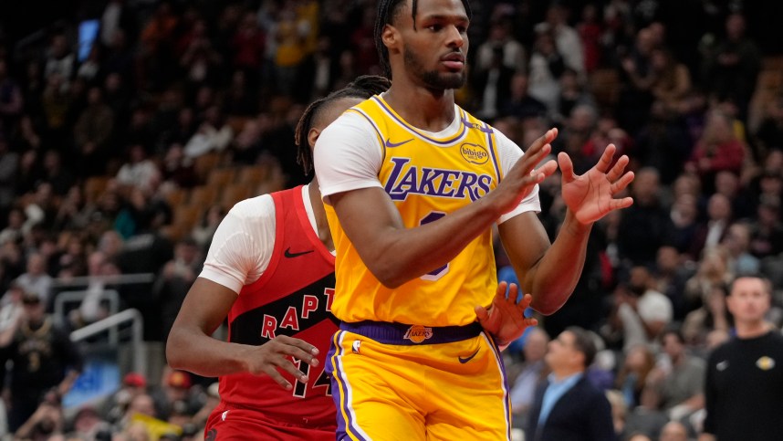 Nov 1, 2024; Toronto, Ontario, CAN; Los Angeles Lakers guard Bronny James (9) looks for a pass as Toronto Raptors guard Ja'Kobe Walter (14) defends during the second half at Scotiabank Arena. Mandatory Credit: John E. Sokolowski-Imagn Images