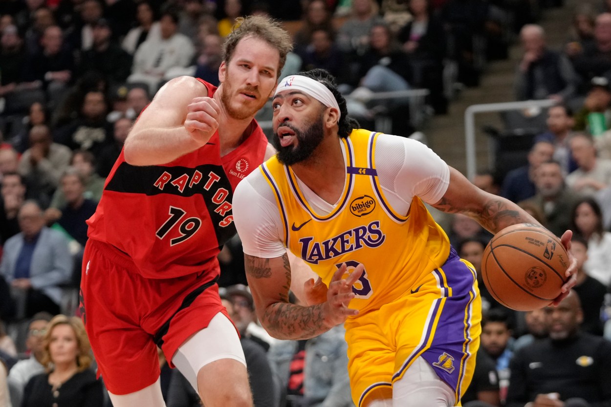 Nov 1, 2024; Toronto, Ontario, CAN; Los Angeles Lakers forward Anthony Davis (3) drives to the net past Toronto Raptors center Jakob Poeltl (19) during the first half at Scotiabank Arena. Mandatory Credit: John E. Sokolowski-Imagn Images