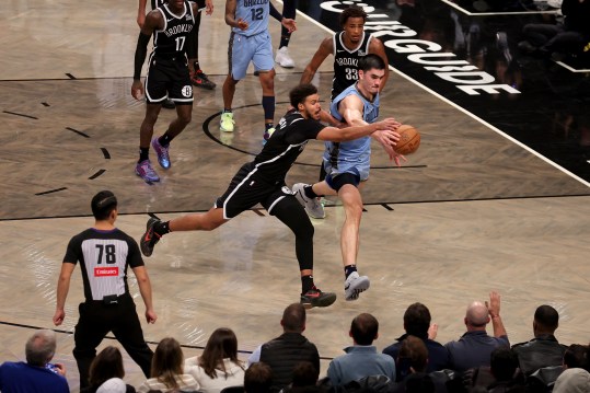 Nov 4, 2024; Brooklyn, New York, USA; Memphis Grizzlies center Zach Edey (14) fights for a loose ball against Brooklyn Nets forward Cameron Johnson (2) and center Nic Claxton (33) during the fourth quarter at Barclays Center. Mandatory Credit: Brad Penner-Imagn Images