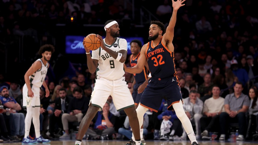 Nov 8, 2024; New York, New York, USA; Milwaukee Bucks forward Bobby Portis (9) looks to pass the ball against New York Knicks center Karl-Anthony Towns (32) during the fourth quarter at Madison Square Garden. Mandatory Credit: Brad Penner-Imagn Images