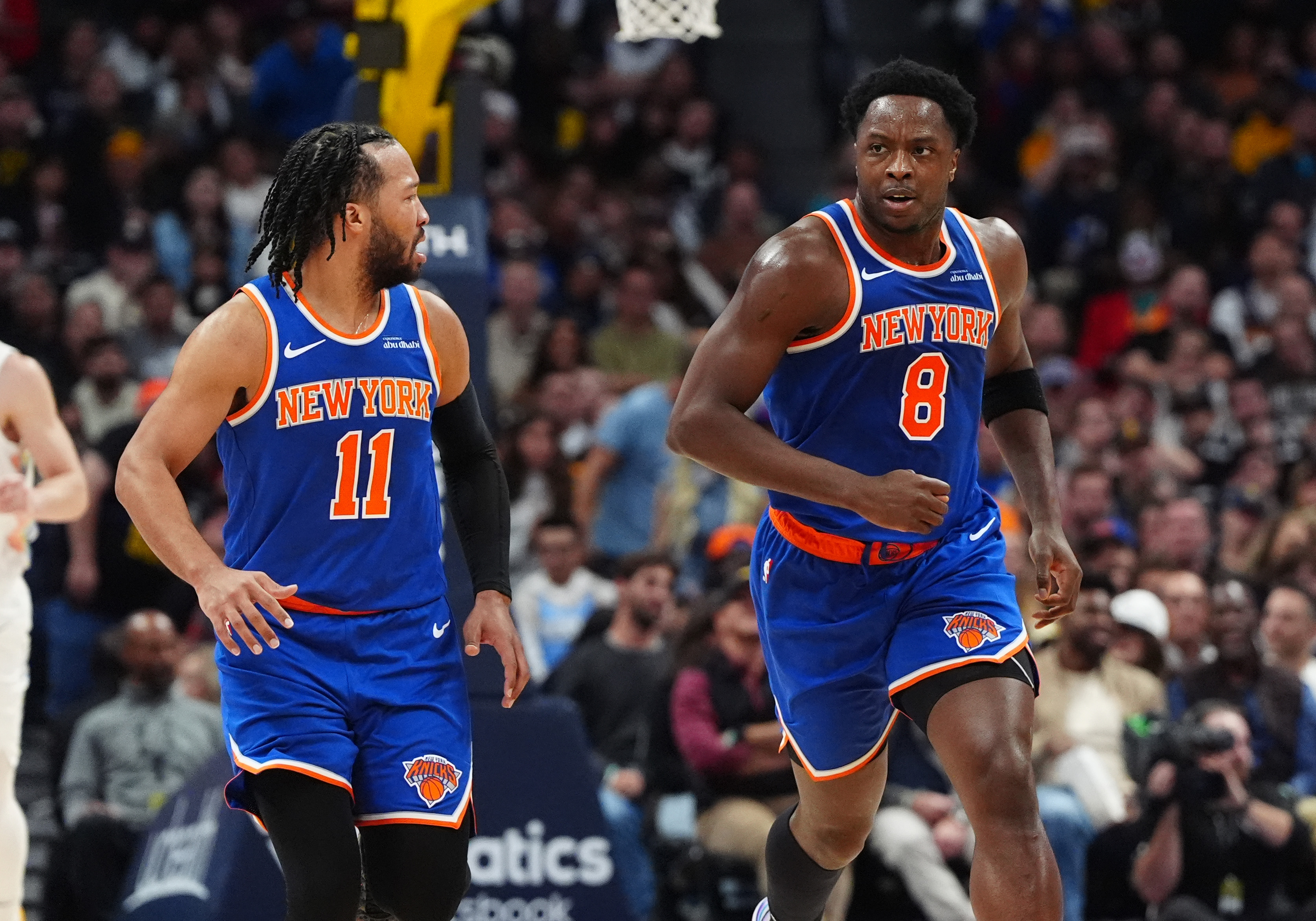 Nov 25, 2024; Denver, Colorado, USA; New York Knicks guard Jalen Brunson (11) reacts towards forward OG Anunoby (8) in the second quarter against the Denver Nuggets at Ball Arena. Mandatory Credit: Ron Chenoy-Imagn Images