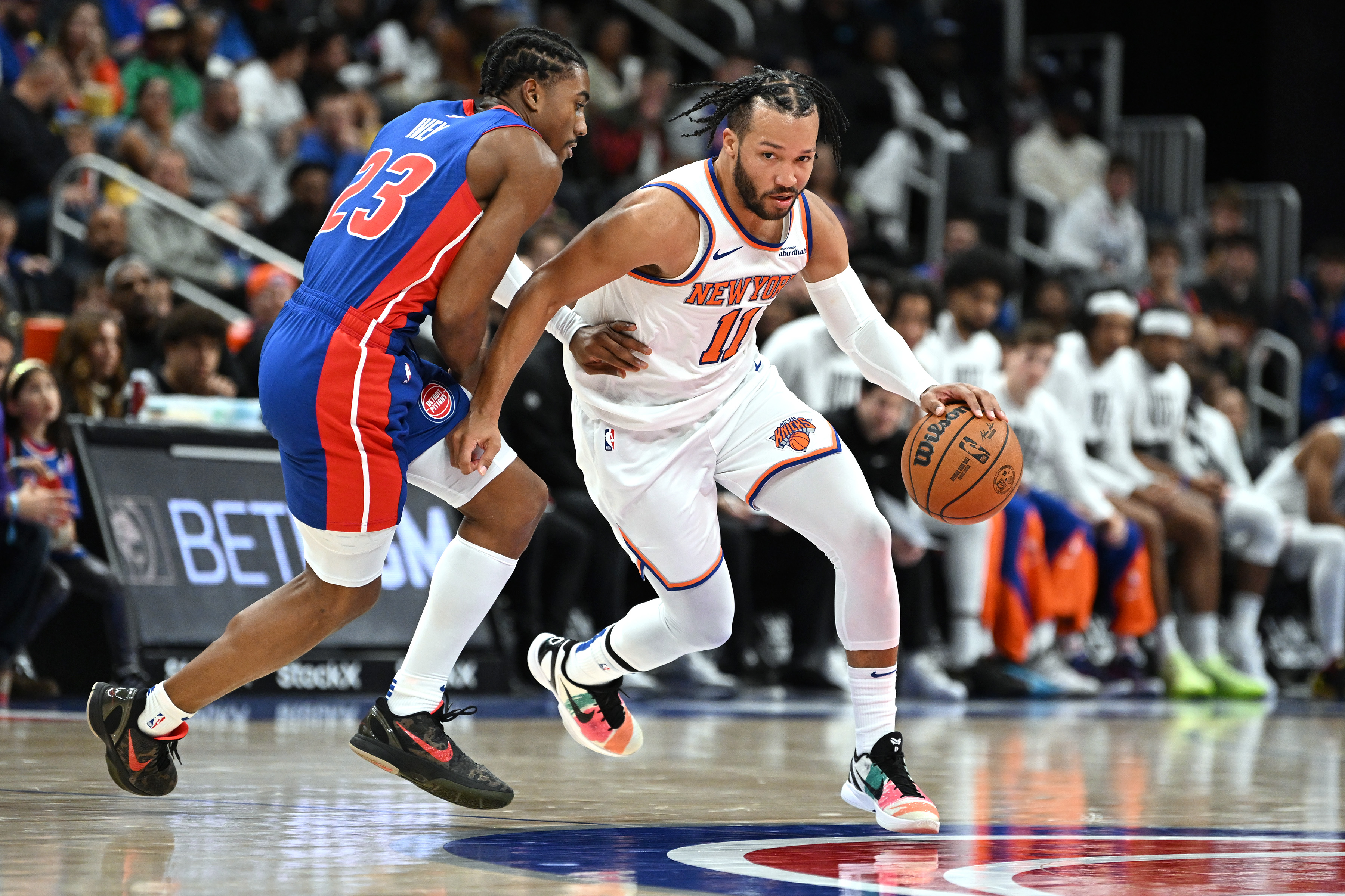 Nov 1, 2024; Detroit, Michigan, USA; New York Knicks guard Jalen Brunson (11) drive past Detroit Pistons guard Jaden Ivey (23) in the third quarter at Little Caesars Arena. Mandatory Credit: Lon Horwedel-Imagn Images