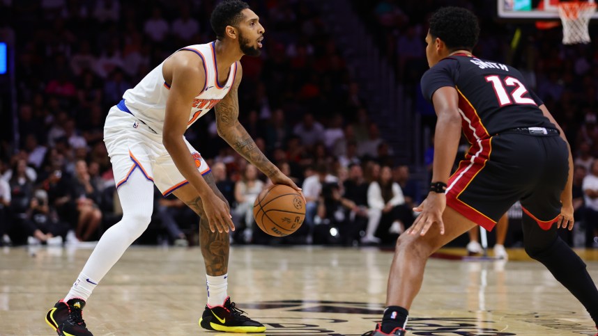 Oct 30, 2024; Miami, Florida, USA; New York Knicks guard Cameron Payne (1) dribbles the basketball as Miami Heat guard Dru Smith (12) defends during the third quarter at Kaseya Center. Mandatory Credit: Sam Navarro-Imagn Images