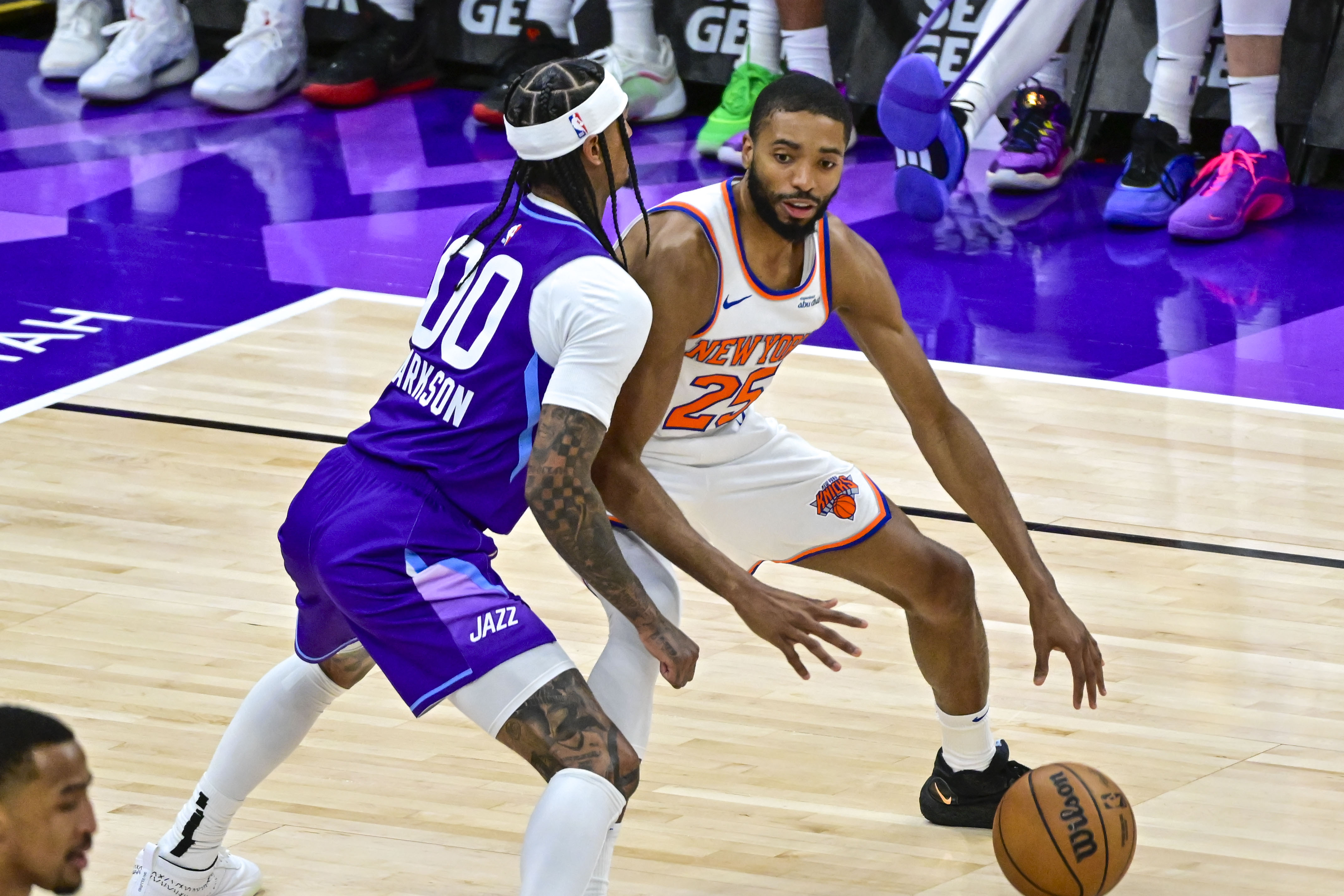 Nov 23, 2024; Salt Lake City, Utah, USA; New York Knicks guard/forward Mikal Bridges (25) dribbles the ball against Utah Jazz guard Jordan Clarkson (00) during the second half at the Delta Center. Mandatory Credit: Christopher Creveling-Imagn Images