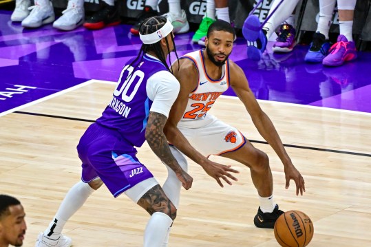 Nov 23, 2024; Salt Lake City, Utah, USA; New York Knicks guard/forward Mikal Bridges (25) dribbles the ball against Utah Jazz guard Jordan Clarkson (00) during the second half at the Delta Center. Mandatory Credit: Christopher Creveling-Imagn Images