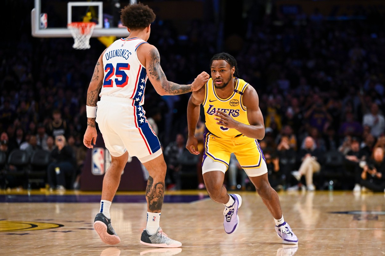 Nov 8, 2024; Los Angeles, California, USA; Los Angeles Lakers guard Bronny James (9) runs past Philadelphia 76ers guard Lester Quinones (25) during the second half at Crypto.com Arena. Mandatory Credit: Jonathan Hui-Imagn Images