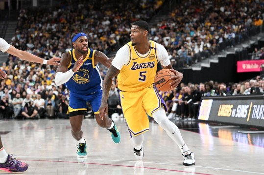 Oct 15, 2024; Las Vegas, Nevada, USA; Los Angeles Lakers forward Cam Reddish (5) drives past Golden State Warriors guard Buddy Hield (7) in the third quarter during a preseason game at T-Mobile Arena. Mandatory Credit: Candice Ward-Imagn Images