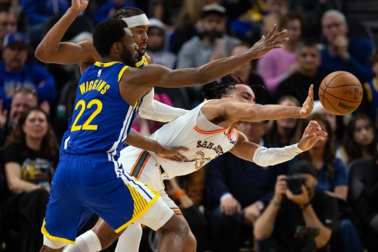 Mar 9, 2024; San Francisco, California, USA; San Antonio Spurs guard Tre Jones (33) passes away from defensive pressure by Golden State Warriors defenders Andrew Wiggins (22) and Moses Moody during the fourth quarter at Chase Center. Mandatory Credit: D. Ross Cameron-Imagn Images