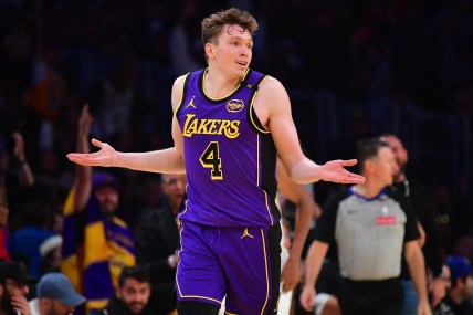 Nov 19, 2024; Los Angeles, California, USA; Los Angeles Lakers guard Dalton Knecht (4) react after scoring a three point basket against the Utah Jazz during the second half at Crypto.com Arena. Mandatory Credit: Gary A. Vasquez-Imagn Images