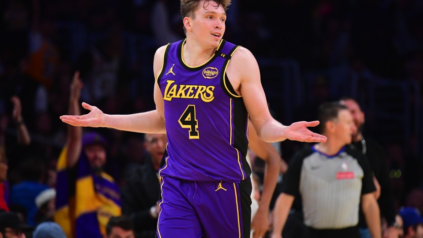 Nov 19, 2024; Los Angeles, California, USA; Los Angeles Lakers guard Dalton Knecht (4) react after scoring a three point basket against the Utah Jazz during the second half at Crypto.com Arena. Mandatory Credit: Gary A. Vasquez-Imagn Images