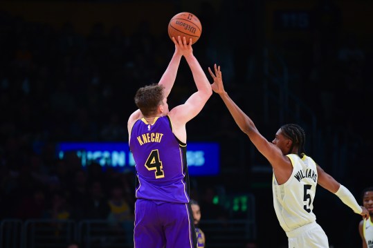 Nov 19, 2024; Los Angeles, California, USA; Los Angeles Lakers guard Dalton Knecht (4) shoots a three point basket against Utah Jazz forward Cody Williams (5) during the second half at Crypto.com Arena. Mandatory Credit: Gary A. Vasquez-Imagn Images