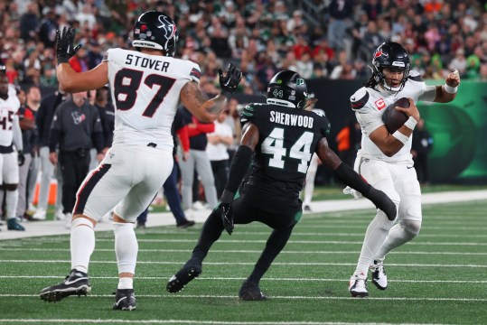 Oct 31, 2024; East Rutherford, New Jersey, USA; Houston Texans quarterback C.J. Stroud (7) runs with the ball while New York Jets linebacker Jamien Sherwood (44) attempts to tackle him during the first half at MetLife Stadium. Mandatory Credit: Ed Mulholland-Imagn Images