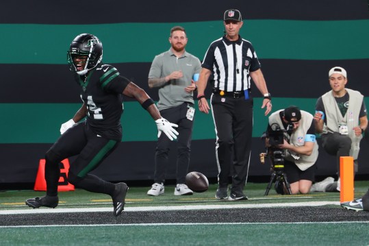 Oct 31, 2024; East Rutherford, New Jersey, USA; New York Jets wide receiver Malachi Corley (14) drops the ball prior to crossing the goal line against the Houston Texans during the first half at MetLife Stadium. Mandatory Credit: Ed Mulholland-Imagn Images