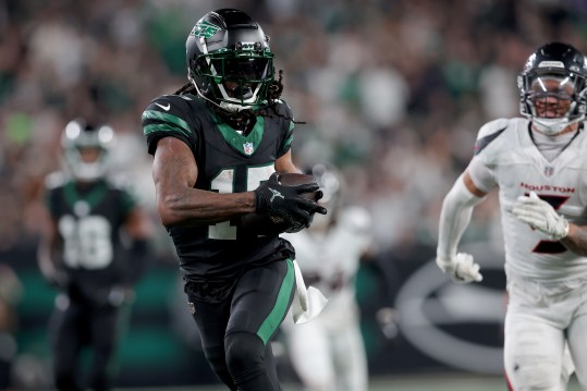 Oct 31, 2024; East Rutherford, New Jersey, USA; New York Jets wide receiver Davante Adams (17) runs with the ball for a touchdown against Houston Texans safety Jalen Pitre (5) during the fourth quarter at MetLife Stadium. Mandatory Credit: Brad Penner-Imagn Images