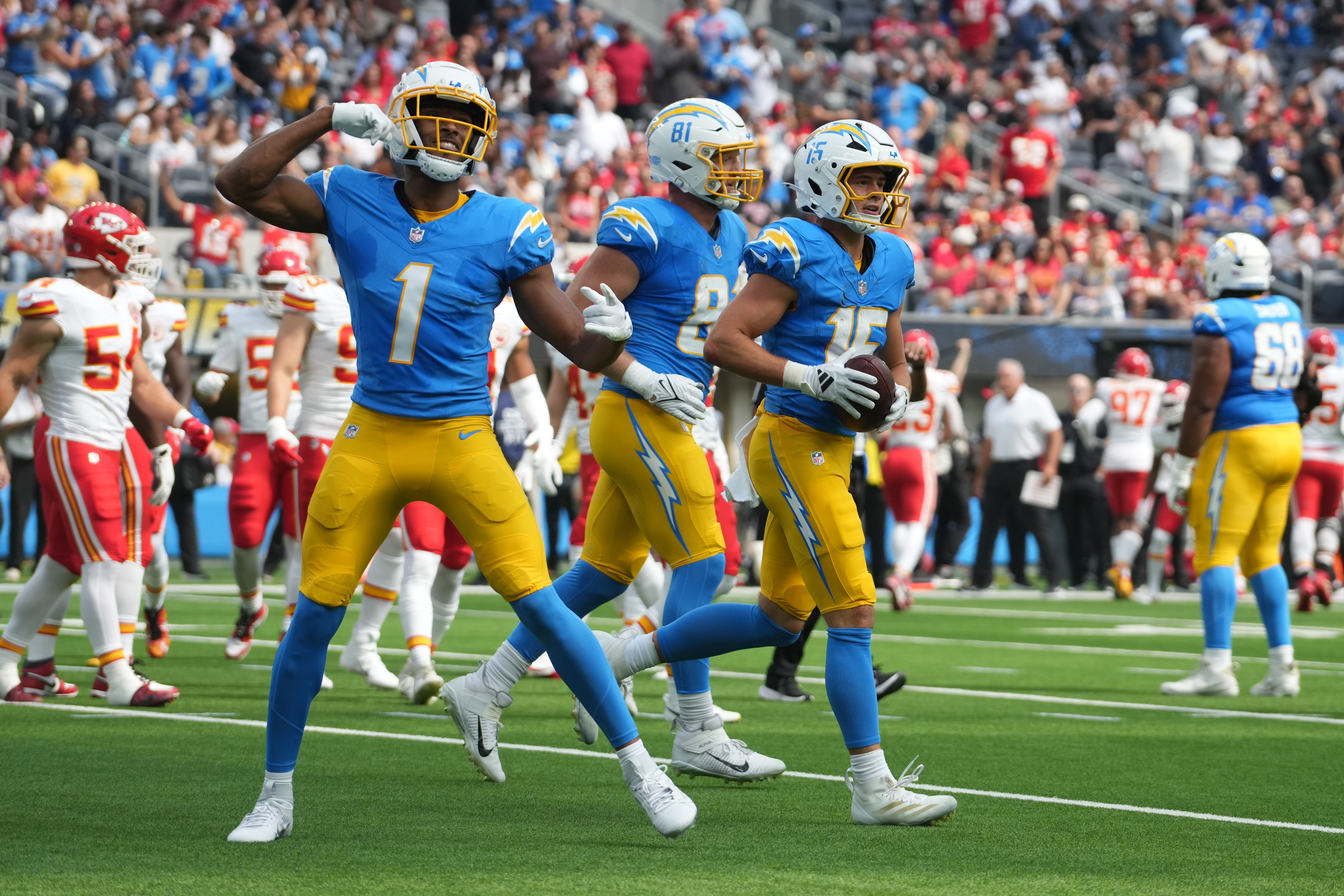 Sep 29, 2024; Inglewood, California, USA; Los Angeles Chargers wide receiver Ladd McConkey (15) celebrates with wide receiver Quentin Johnston (1) and 	ight end Will Dissly (81) after catching a 7-yard touchdown pass against the Kansas City Chiefs in the first quarter at SoFi Stadium. Mandatory Credit: Kirby Lee-Imagn Images