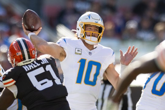 Nov 3, 2024; Cleveland, Ohio, USA; Los Angeles Chargers quarterback Justin Herbert (10) throws the ball against the Cleveland Browns during the first quarter at Huntington Bank Field. Mandatory Credit: Scott Galvin-Imagn Images