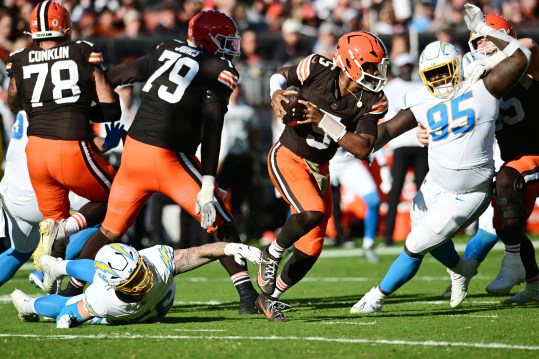 Nov 3, 2024; Cleveland, Ohio, USA; Cleveland Browns quarterback Jameis Winston (5) scrambles from Los Angeles Chargers defensive end Morgan Fox (56) during the first half at Huntington Bank Field. Mandatory Credit: Ken Blaze-Imagn Images