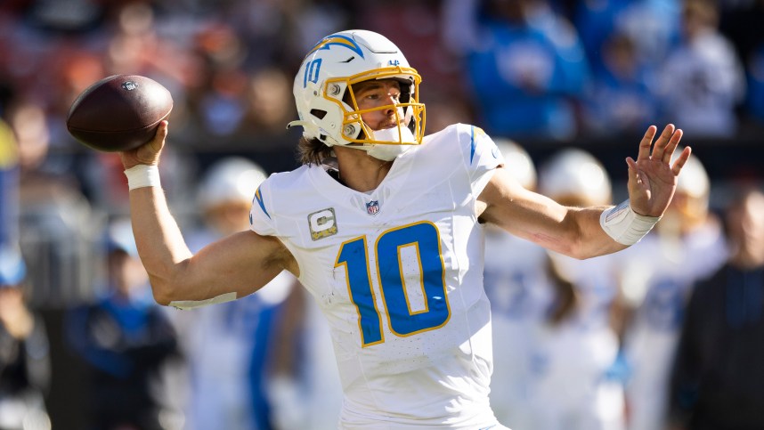 Nov 3, 2024; Cleveland, Ohio, USA; Los Angeles Chargers quarterback Justin Herbert (10) throws the ball against the Cleveland Browns during the second quarter at Huntington Bank Field. Mandatory Credit: Scott Galvin-Imagn Images