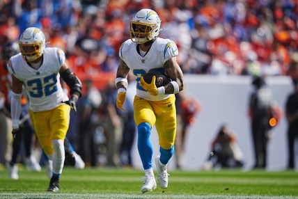 Oct 13, 2024; Denver, Colorado, USA; Los Angeles Chargers cornerback Elijah Molden (22) returns a interception in the first quarter against the Denver Broncos at Empower Field at Mile High. Mandatory Credit: Ron Chenoy-Imagn Images