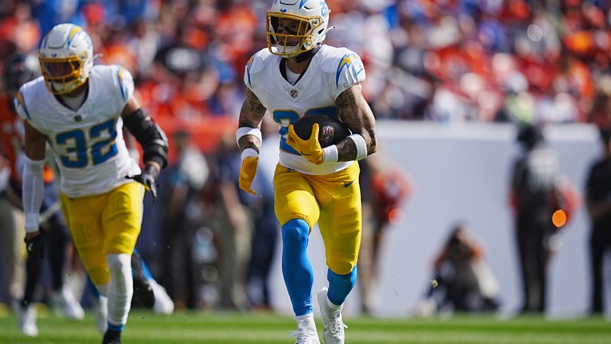 Oct 13, 2024; Denver, Colorado, USA; Los Angeles Chargers cornerback Elijah Molden (22) returns a interception in the first quarter against the Denver Broncos at Empower Field at Mile High. Mandatory Credit: Ron Chenoy-Imagn Images