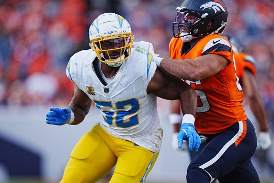 Oct 13, 2024; Denver, Colorado, USA; Denver Broncos tight end Thomas Yassmin (86) blocks on Los Angeles Chargers linebacker Khalil Mack (52) in the second half at Empower Field at Mile High. Mandatory Credit: Ron Chenoy-Imagn Images