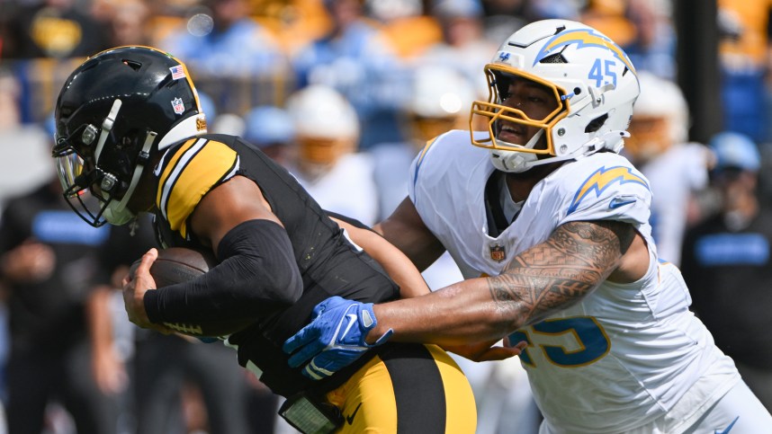 Sep 22, 2024; Pittsburgh, Pennsylvania, USA; Pittsburgh Steelers quarterback Justin Fields (2) is tackled by Los Angeles Chargers linebacker Tuli Tuipulotu (45) during the first quarter at Acrisure Stadium. Mandatory Credit: Barry Reeger-Imagn Images