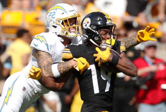 Sep 22, 2024; Pittsburgh, Pennsylvania, USA;  Pittsburgh Steelers wide receiver Calvin Austin III (19) fights of a tackle attempt by Los Angeles Chargers cornerback Elijah Molden (22) to score a fifty-five yard touchdown during the fourth quarter at Acrisure Stadium. Pittsburgh won 20-10. Mandatory Credit: Charles LeClaire-Imagn Images