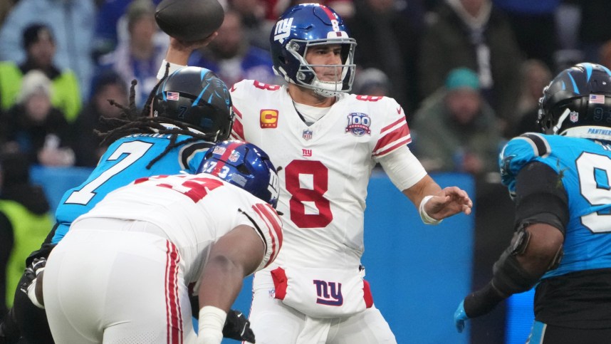 Nov 10, 2024; Munich, Germany; New York Giants quarterback Daniel Jones (8) throws the ball against the Carolina Panthers in the first half during the 2024 NFL Munich Game at Allianz Arena. Mandatory Credit: Kirby Lee-Imagn Images