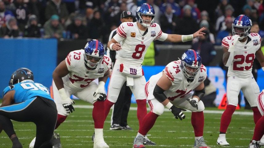 Nov 10, 2024; Munich, Germany; New York Giants quarterback Daniel Jones (8) prepares to take the snap against the Carolina Panthers in the first half during the 2024 NFL Munich Game at Allianz Arena. Mandatory Credit: Kirby Lee-Imagn Images