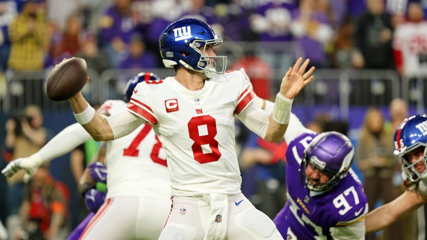 Jan 15, 2023; Minneapolis, Minnesota, USA; New York Giants quarterback Daniel Jones (8) passes the ball against the Minnesota Vikings during the first quarter of a wild card game at U.S. Bank Stadium. Mandatory Credit: Matt Krohn-Imagn Images