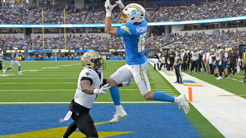 Oct 27, 2024; Inglewood, California, USA;  Los Angeles Chargers wide receiver Ladd McConkey (15) hangs on the the ball for a touchdown as he is defended by New Orleans Saints safety Ugo Amadi (0) in the second half at SoFi Stadium. Mandatory Credit: Jayne Kamin-Oncea-Imagn Images