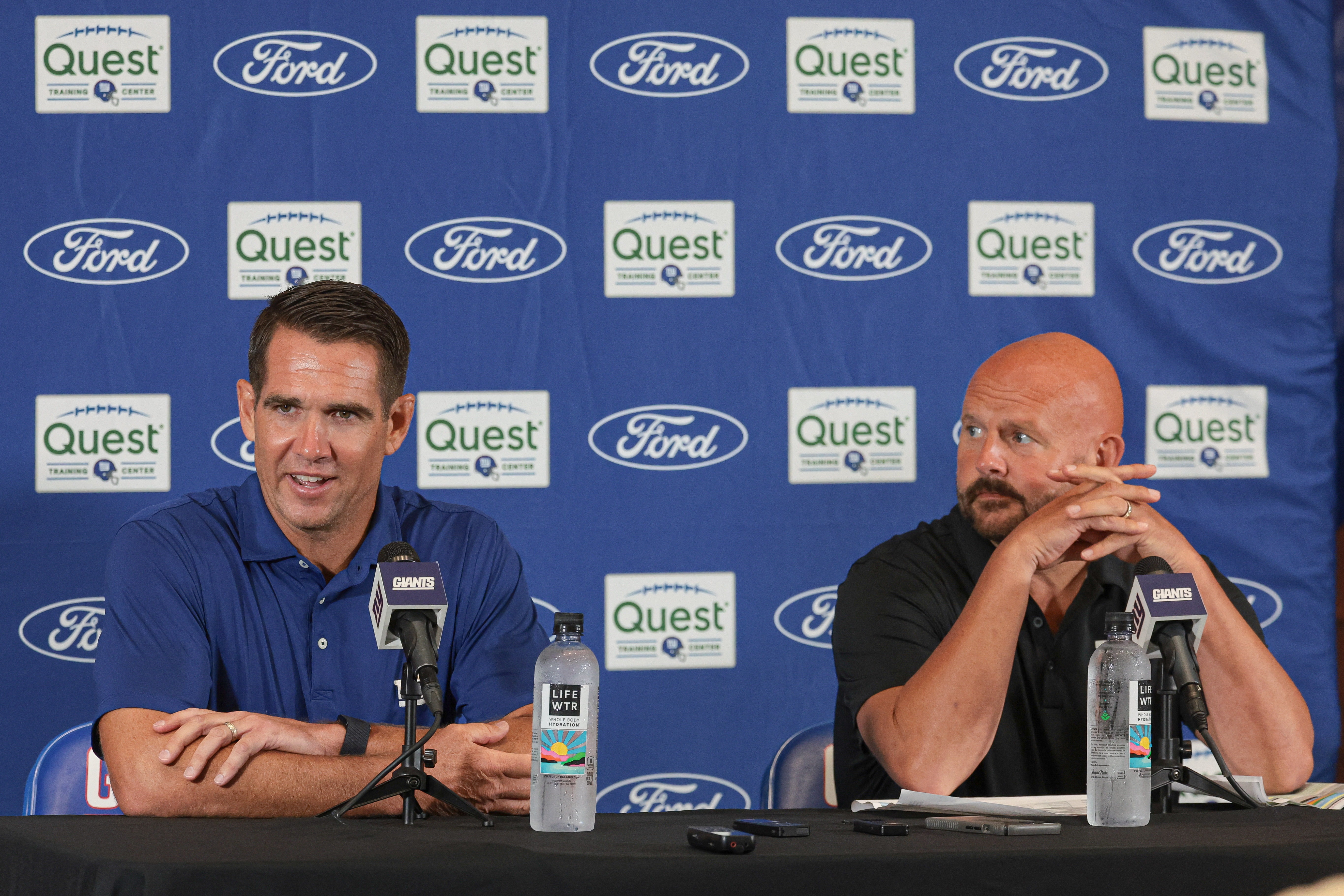 Jul 24, 2024; East Rutherford, NJ, USA; New York Giants general manager Joe Schoen (left) and head coach Brian Dabol talks to media before the start of training camp at Quest Diagnostics Training Facility. Mandatory Credit: Vincent Carchietta-Imagn Images