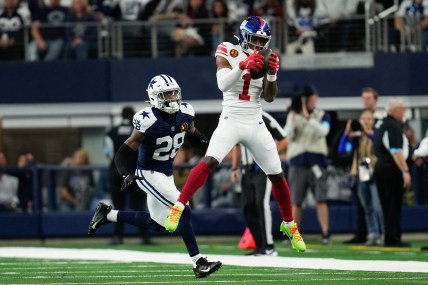 Nov 28, 2024; Arlington, Texas, USA;  New York Giants wide receiver Malik Nabers (1) catches a pass as Dallas Cowboys safety Malik Hooker (28) gives chase during the first half at AT&T Stadium. Mandatory Credit: Chris Jones-Imagn Images