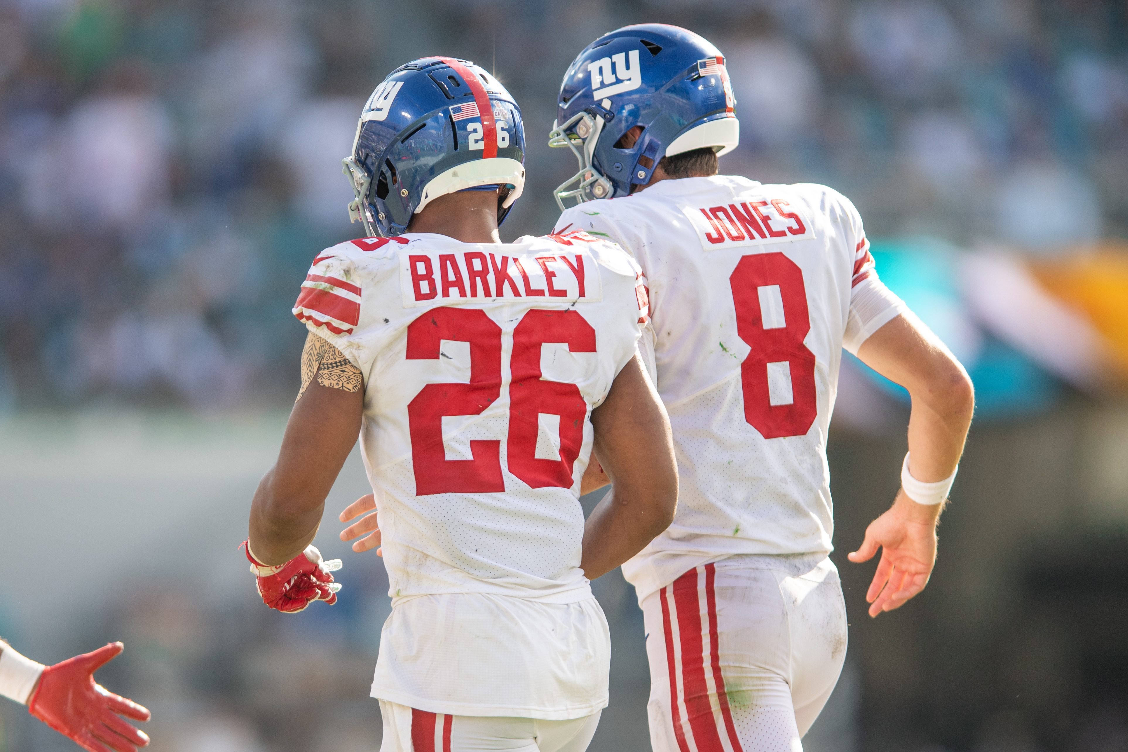 Oct 23, 2022; Jacksonville, Florida, USA; New York Giants quarterback Daniel jones (8) and running back Saquon Barkley (26) celebrate a touchdown against the Jacksonville Jaguars in the fourth quarter at TIAA Bank Field. Mandatory Credit: Jeremy Reper-Imagn Images