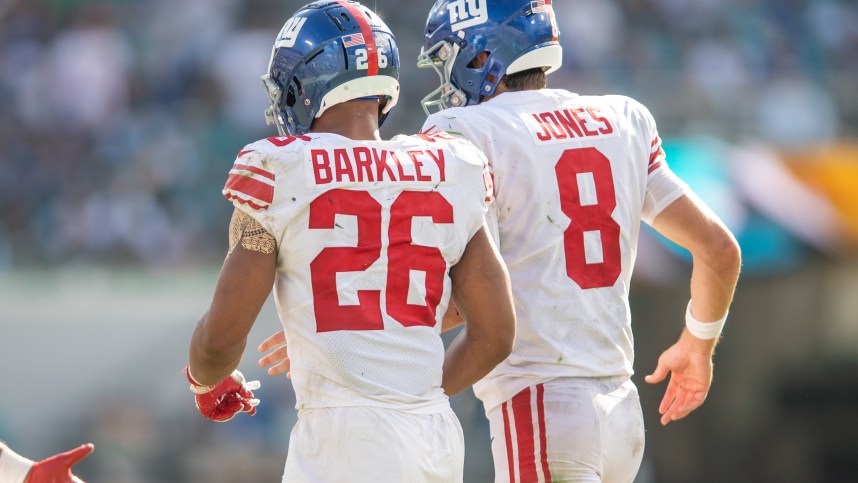 Oct 23, 2022; Jacksonville, Florida, USA; New York Giants quarterback Daniel jones (8) and running back Saquon Barkley (26) celebrate a touchdown against the Jacksonville Jaguars in the fourth quarter at TIAA Bank Field. Mandatory Credit: Jeremy Reper-Imagn Images