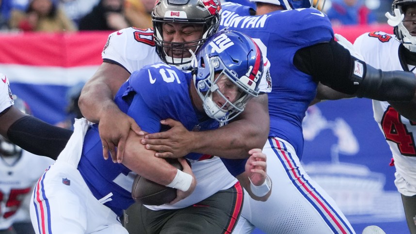 Nov 24, 2024; East Rutherford, New Jersey, USA; New York Giants quarterback Tommy DeVito (15) is sacked by Tampa Bay Buccaneers defensive tackle Vita Vea (50) during the first half at MetLife Stadium. Mandatory Credit: Robert Deutsch-Imagn Images