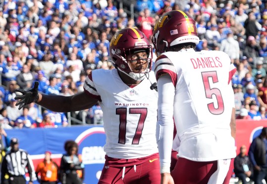 Nov 3, 2024; East Rutherford, New Jersey, USA; Washington Commanders wide receiver Terry McLaurin (17) after a 1st quarter towchdown reception from quarterback Jayden Daniels (5) against the New York Giants at MetLife Stadium. Mandatory Credit: Robert Deutsch-Imagn Images