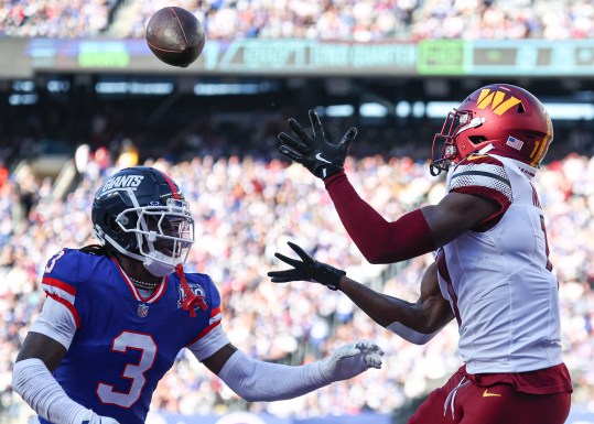 Nov 3, 2024; East Rutherford, New Jersey, USA; Washington Commanders wide receiver Terry McLaurin (17) catches a touchdown pass as New York Giants cornerback Deonte Banks (3) defends during the first half at MetLife Stadium. Mandatory Credit: Vincent Carchietta-Imagn Images