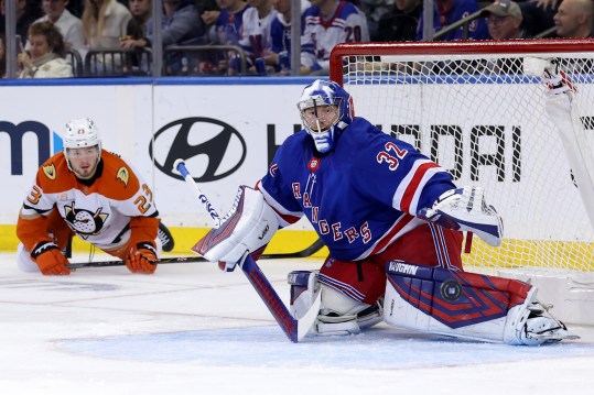 Oct 26, 2024; New York, New York, USA; New York Rangers goaltender Jonathan Quick (32) plays the puck against Anaheim Ducks center Mason McTavish (23) during the second period at Madison Square Garden. Mandatory Credit: Brad Penner-Imagn Images