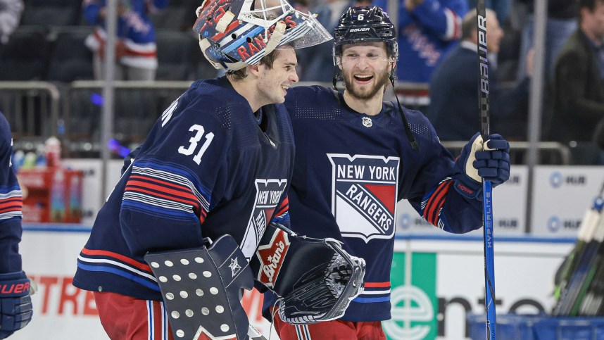 Mar 17, 2024; New York, New York, USA; New York Rangers defenseman Zac Jones (6) celebrates with goaltender Igor Shesterkin (31) after the game against the New York Islanders at Madison Square Garden. Mandatory Credit: Vincent Carchietta-Imagn Images