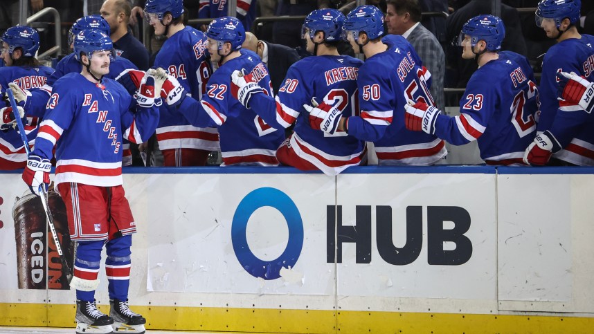 Nov 1, 2024; New York, New York, USA;  New York Rangers left wing Alexis Lafrenière (13) celebrates with his teammates after scoring a goal in the third period against the Ottawa Senators at Madison Square Garden. Mandatory Credit: Wendell Cruz-Imagn Images